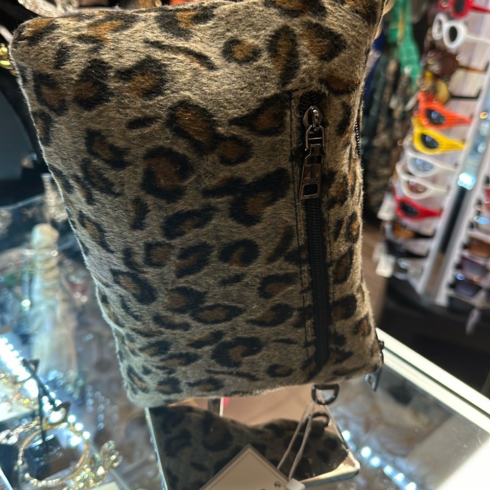 A Vegan animal print clutch with a shoulder strap